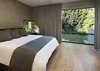 The minimal master bedroom overlooks the back yard. Photo 11 of Cohen Residence modern home