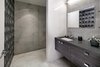 Exposed concrete in the office bathroom compliments the raw materials seen throughout the basement level. Photo 14 of Cohen Residence modern home
