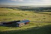 Forming a contemporary X, the home gracefully stretches its elongated wings into the countryside’s expanse. The unconventional shape of the house allows for different views from every room, while also creating a very functional living space with private and public wings that are connected by a family playroom at the junction. Photo of Casper Residence modern home