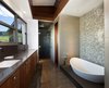 Redwood paneling is also seen in the master bathroom, complimenting the cool-toned mosaic tiles. Photo 8 of Casper Residence modern home