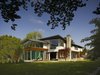 The second floor is light and almost without walls. The roof flies above and its apparent lightness is expressed by its thin, six inch profiles. Photo of Davis Residence modern home
