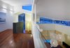 A sloped roof connects the living room with the upstairs hall. Large spherical lighting adds drama to the open space. Photo 7 of Davis Residence modern home