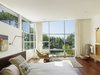 Upstairs, the airy bedrooms open to a central hall with a sitting area, lit by clearstory windows and finished with crisp white walls. Photo 8 of Davis Residence modern home