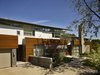 Redwood siding adds warmth to the neutral stone and stucco textures for a Mid-Century touch to a contemporary form. Photo 12 of Davis Residence modern home