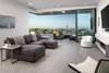 Interior space and material extend onto the patio under a cantilevered overhang that shelters an outdoor living area. Photo 4 of Glenhaven Residence modern home