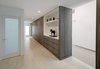 The color palette and grey wood finishes are carried throughout the home for a clean consistency. Photo 7 of Glenhaven Residence modern home