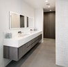An accent wall with marble mosaic tile adds texture to the sleek bathroom. Photo 9 of Glenhaven Residence modern home