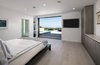 Pocket doors in the bedroom completely open up onto the patio for an indoor-outdoor lifestyle. Photo 10 of Glenhaven Residence modern home
