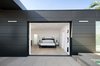 Dark metal siding creates subtle stripes with varying widths for architectural interest. Photo 11 of Glenhaven Residence modern home