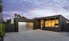 Exterior materials were selected for their desired low maintenance; Trespa, Swiss Pearl, and metal siding wrap the facade and create a refined, simple, modern look. Photo of Glenhaven Residence modern home