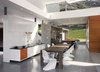 The open plan features living spaces with a high ceiling and clerestory windows that allow soft filtered light to enter every room. Photo 4 of Lima Residence modern home