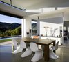 Sliding glass pocket doors fully open to unify these exterior and interior spaces, thus expanding the living spaces to incorporate the outdoors. Photo 5 of Lima Residence modern home
