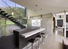 Concrete walls add an industrial touch to the polished home. Photo 6 of Lima Residence modern home