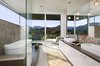 A stunning bathroom opens onto a patio for striking canyon views. Photo 8 of Lima Residence modern home