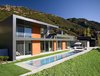 A narrow pool is nestled into the back yard next to an outdoor living area. Photo 9 of Lima Residence modern home