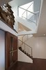 Inside, a ledge above the door holds an antique water wheel, a notable piece belonging to the Client. This wheel is backlit with a large window adjacent to it. Top floor skylights add dramatic light which filters down a multi-tiered staircase. Photo 3 of Perrin Residence modern home