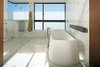 Bookmatched marble panels cover the walls while a coordinating marble mosaic serves as flooring. Photo 7 of Perrin Residence modern home