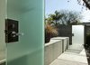 An additional view of the linear concrete partition shows it continuing inside the front door. Photo 3 of Goodman Residence modern home