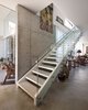 The staircase also serves as a divider between the glass half of the home, on the left, and the more solid counterpart, on the right. Photo 5 of Goodman Residence modern home