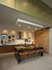 The Mid-Century style kitchen is recessed, framed in the same green Trespa panels on the exterior of the home, further incorporating an indoor-outdoor setup that is popular in Venice Beach. Photo 6 of Goodman Residence modern home