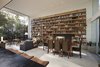 The homeowner possessed a brilliant collection of books, which are showcased in sprawling built-in book shelves in the living room. Photo 7 of Goodman Residence modern home