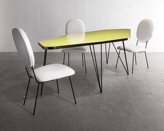 Also shown with Joaquim Tenreiro’s edgy dining table, was a set of 1960s dining chairs with white leather upholstery and painted iron frames. 