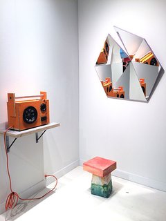 Stonefox Architect’s mirror series includes five different faceted shapes in five high-gloss colors. Each mirror started with flat pieces that were fit together like a puzzle. Standing below the mirror, is Kueng Caputo’s Sand Chair, formed out of Styrofoam, mortar, sand, and bright-colored pigment pastes. Also shown here is Tom Sachs's Mythologies, a mixed media art piece that mimics a speaker—and actually works.