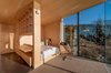 Modern home with Bedroom, Bed, Chair, Shelves, and Wall Lighting. Each hut consists of two bedrooms with double beds, a small alcove, bathroom, shower, and small kitchen. Stinessen made sure to provide enough built-in storage for visitors, while also keeping the surfaces natural and raw. Photo 5 of Manshausen Island