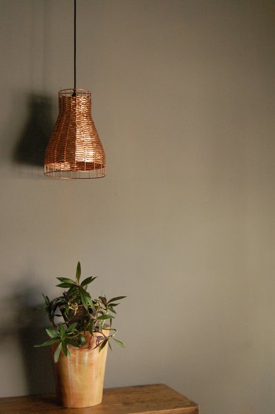 The process of turning recycled copper into a modern lamp can take one to two days per piece. Once the hammered or woven pieces are finished, they’re heat-treated to seal in a patina, or polished for a pure copper shine.