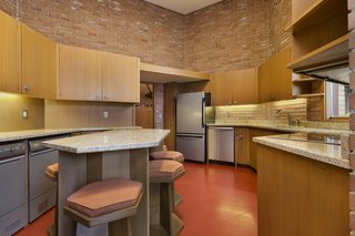 In the kitchen, the same materials and shapes used throughout the house are echoed, including the custom barstools that surround the kitchen island—which bear a resemblance to the seating pieces he designed for the living room. 