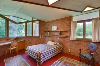 In one of the three bedrooms, Wright designed this built-in desk and chair. The angular windows and skylights are continued into the bedrooms.