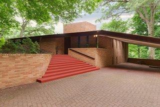Though 2206 Parklands Lane is located near downtown Minneapolis, it sits on a quiet 3.77-acre piece of land. When you approach the brick home, its wing-like shape and Cherokee Red-painted steps practically scream Frank Lloyd Wright.