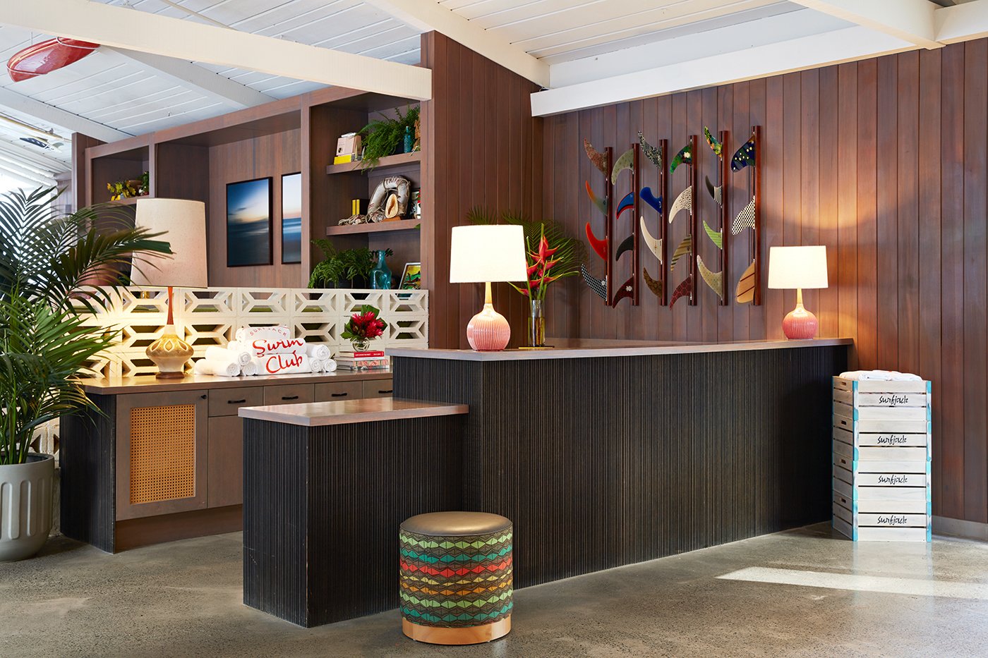 While checking in, you’re welcomed into an open-air space that’s surrounded by locally-sourced TK wood. You’ll also see a surfboard fin installation by TK and custom Surfjack crates that were created by Retrospect Designs.
