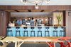 Modern home with Dining Room, Bar, Stools, Pendant Lighting, and Table. As chef Ed Kenney’s fourth eatery, Mahina & Sun’s believes in, “local first; organic whenever possible; with aloha always.” The picnic tables next to the bar were hand-painted by local artist Jeff Gress. Photo 6 of The Surfjack Hotel & Swim Club