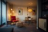 Modern home with Dining Room, Bench, Table, Wall Lighting, Chair, and Carpet Floor. The rooms also include custom lounge chairs, tables, spring pole lamps, and rattan chairs. Photo 11 of The Laylow