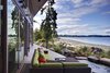 The main house is clad in the local Douglas fir with deep protective eaves, stained grey to match the sun-bleached drift wood logs that litter the coast.
#facade #residential #residentialarchitecture #coastline #beachhouse #beachhouses #view #porch #beachfront #britishcolumbia #vancouverislands #bradlaughton #bradlaughtonphotography Photo 9 of TreeHugger modern home