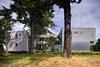 two interconnected buildings protect and reinforce the stand of giant firs while accommodating a hybrid program. The main house is an isolated wood tube which creates a giant aperture framing both the Canadian Rockies (across the Georgia Straight) and the coastal wetlands (to the landward side). A semi-enclosed bridge extends through the trees from the seasonally closable guest house clad in cement panels over the porte-cochere of folding translucent panels.
#glasswalkway #residential #residentialarchicture #green #nature #residential #beachhouse #beachhouses #interstice #britishcolumbia #vancouverislands #comox #intersticearchitects #trees #bradlaughton #bradlaughtonphotography Photo 7 of TreeHugger modern home