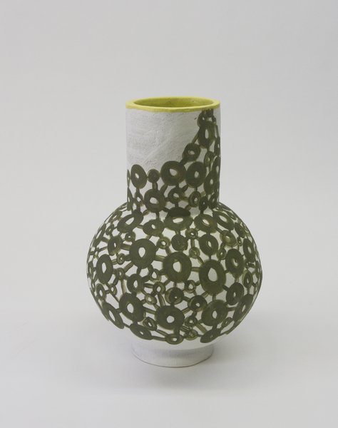 Coated with an olive green, circular graphic, Ziperstein's vessel reinterprets a dress overlaid with a similarly patterned chain-metal mesh, from Comey's spring/summer 2017 collection.