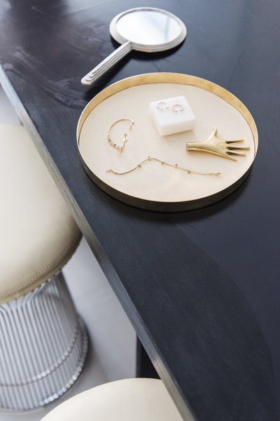 A Carl Auböck Hand paperweight joins a selection of pieces including Jemma Wynne's Revival Snake Chain bracelet.