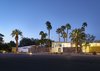 Modern home with Exterior, Stone Siding Material, and Mid-Century Building Type. To recreate that 1960s flair Kathy, a designer, spent four months scouring for vintage treasures. "Because we were buying a Palm Springs midcentury modern hotel, I wanted to furnish it with pieces that made sense and were true to that time period," Kathy says. "That said, I wasn't too strict." That means guests may find an '80s chrome coffee table or Jonathan Adler seconds alongside macrame wall hangings and Gainey pots. Photo of The Monkey Tree Hotel