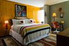 Modern home with Bedroom, Bed, Rug Floor, Lamps, and Medium Hardwood Floor. The idea for the custom room comes from Camp Wandawega's line for Land of Nod, which celebrates the whimsical vintage aesthetic of the retreat. A former Prohibition speakeasy once called "a disgrace to the great state of Wisconsin," Wandawega has come a long way over the years—the 91-year-old camp site is now a boutique lakeside getaway celebrating the simple pleasures of the great outdoors. Photo of Graduate Madison