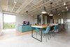 Modern home with Dining Room, Table, Chair, Pendant Lighting, and Light Hardwood Floor. A mix of DSW and DSRA Eames Plastic Side Chairs from Vitra are seated at the dining table, which extends from a stainless steel countertop. Photo of Eames Molded Chairs