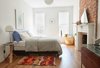 Modern home with Bedroom, Pendant Lighting, Bed, Table Lighting, and Medium Hardwood Floor. "We put a lot of energy—and at least half our investment—into the bones of the building because we intend to be here for a long time," says Lauren Snyder, who resuscitated an aging home alongside her husband, architect Keith Burns. They used simple, basic materials like plaster, brick, and wood throughout to keep it feeling honest, they said. Photo 7 of Bedford-Stuyvesant Brownstone