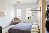 Modern home with Bedroom, Bed, Chair, and Pendant Lighting. “Everything in the bedroom is built in, including the bed,” adds Keith, who commissioned Hub Woodworks to mill this key feature. Andrew Neyer Crane lights flank the bed, an Akari pendant by Isamu Noguchi hangs overhead, and a Womb chair by Eero Saarinen for Knoll, covered in Cassia fabric from Designers Guild, sits in the corner. Photo 13 of Bedford-Stuyvesant Brownstone