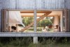 Architects Antje Freiesleben and Johannes Modersohn combined two barn-like wings and a large connecting hall/breezeway for a retreat in New Brunswick. A space between the concrete foundation and the house’s raised wood platform allows the snowmelt to pass through in spring. The 21-foot-wide accordion doors are by HFBB Holzfensterbau Bernau and were shipped from Germany. Photo 2 of House R modern home