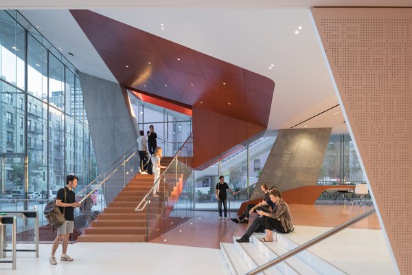 The lobby features seating and a cafe with views overlooking the courts.