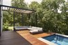 Modern home with Outdoor, Horizontal Fences, Wall, Wood Patio, Porch, Deck, Hardscapes, Vertical Fences, Wall, Swimming Pools, Tubs, Shower, Trees, and Side Yard. Pool deck and sitting area Photo 9 of Lipan House