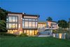 Modern home with Outdoor, Back Yard, Trees, Shrubs, and Grass. Photo courtesy of Holmes, King, Kallquist & Associates provided by Marvin Windows and Doors; project submitted to 2017 Marvin Architects Challenge Photo 5 of Modern Waterfront Residence