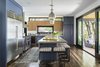 Modern home with Kitchen, Ceiling Lighting, Refrigerator, Range Hood, Range, and Wine Cooler. Photo courtesy of Rehkamp Larson Architects provided by Marvin Windows and Doors Photo 2 of Lake Edge
