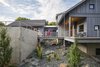 Modern home with Outdoor, Side Yard, Shrubs, Large Patio, Porch, Deck, and Hanging Lighting. Photo courtesy of Rehkamp Larson Architects provided by Marvin Windows and Doors Photo 6 of Lake Edge